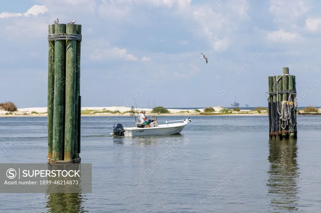 Two men on a fishing boat in Mobile Bay along the coast of Dauphin