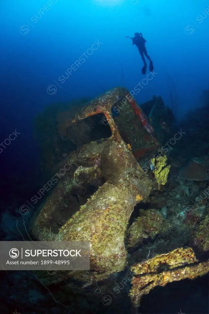 Diver and vintage truck wreck dive. Varsenbaai, Curacao, Netherlands Antilles.