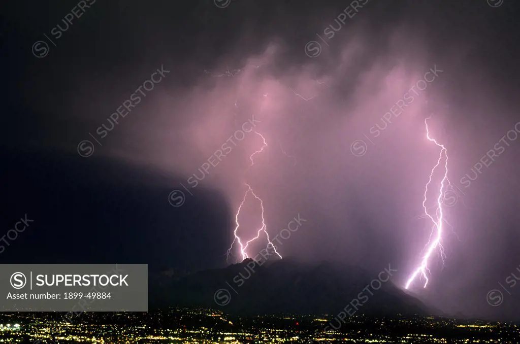 Rainstorm over Santa Catalina Mountains illuminated by cloud-to-ground lightning.  Tucson, Arizona, USA.