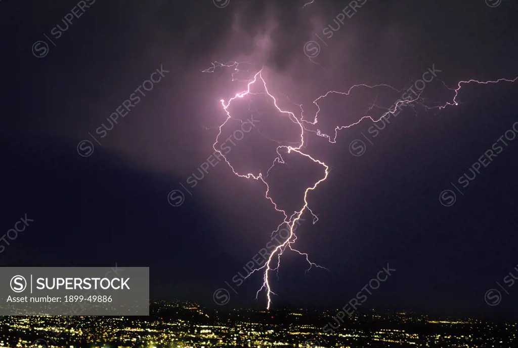 Ground discharge and cloud discharge lightning over city, illustrating lightning channel tortuosity.  Tucson, Arizona, USA.