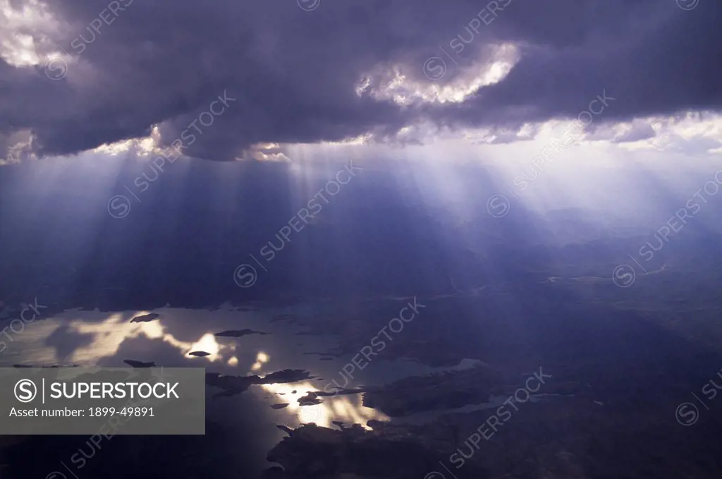 Aerial view of dramatic clouds with light shafts over Lake Mead National Recreation Area.  Northern Arizona, USA.  Verify identity of lake in photo!