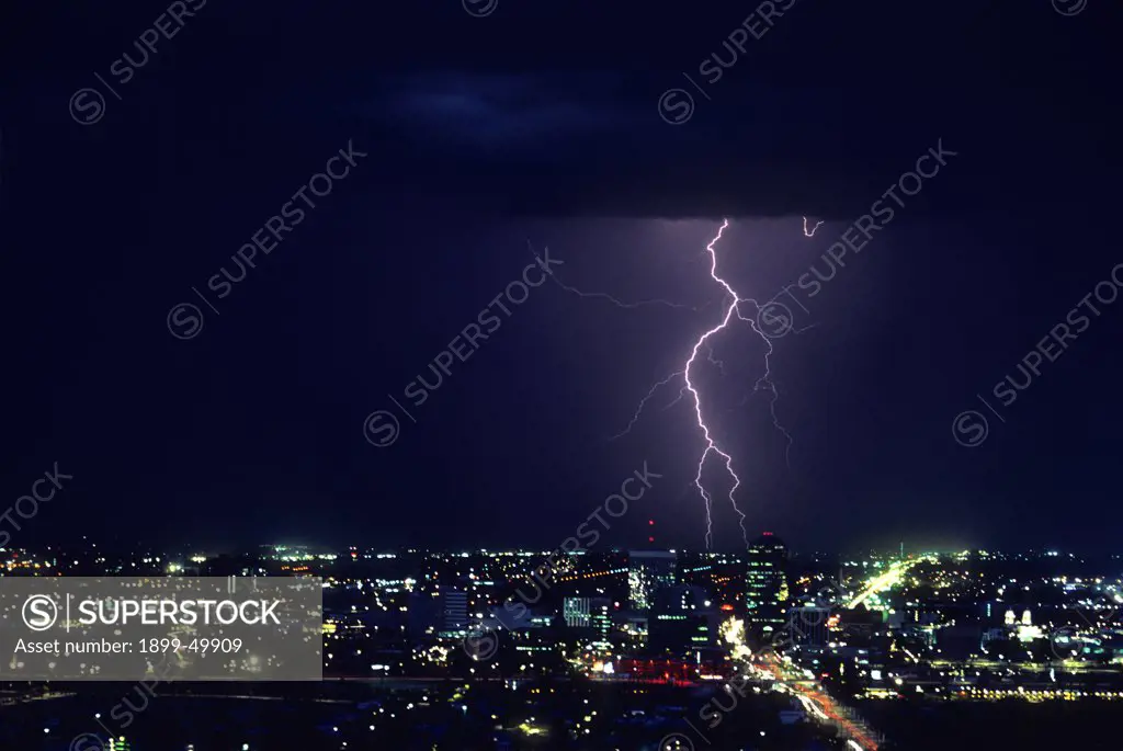 Ground discharge lightning with downtown Tucson in the foreground.  Tucson, Arizona, USA.