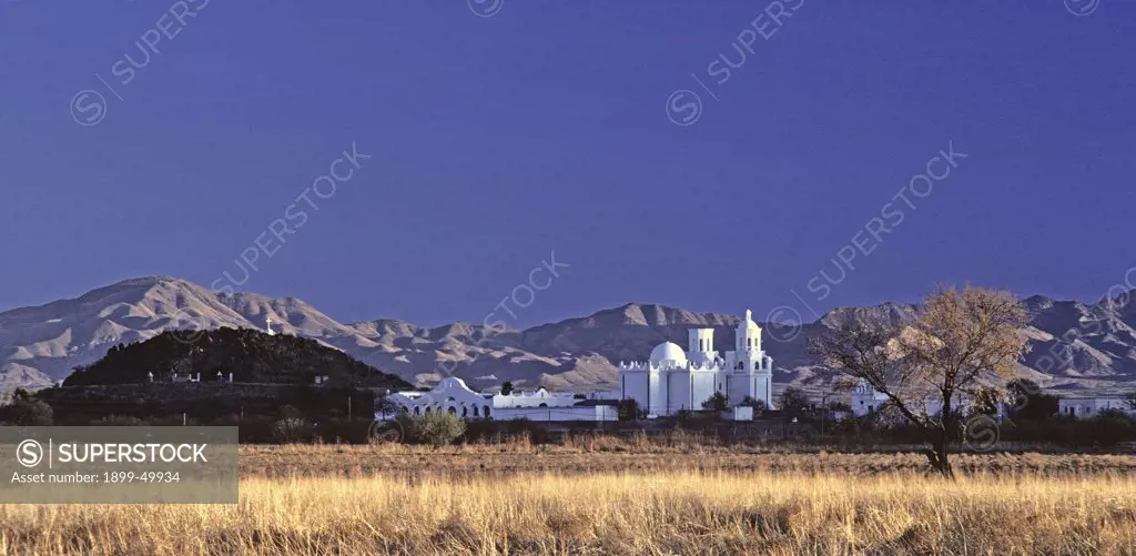 Mission San Xavier del Bac in late afternoon light with backdrop of the Santa Rita Mountains.  Tucson, Arizona, USA.