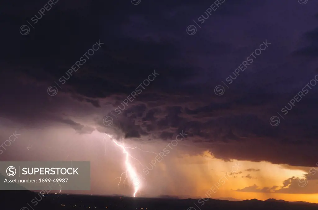 Lightning in a rain curtain at sunset.   Avra Valley, southern Arizona, USA.