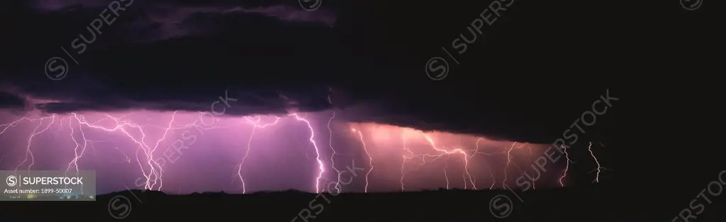 Widespread storm system with much cloud-to-ground lightning.  Marana, Arizona, USA. Panoramic 6x17 film