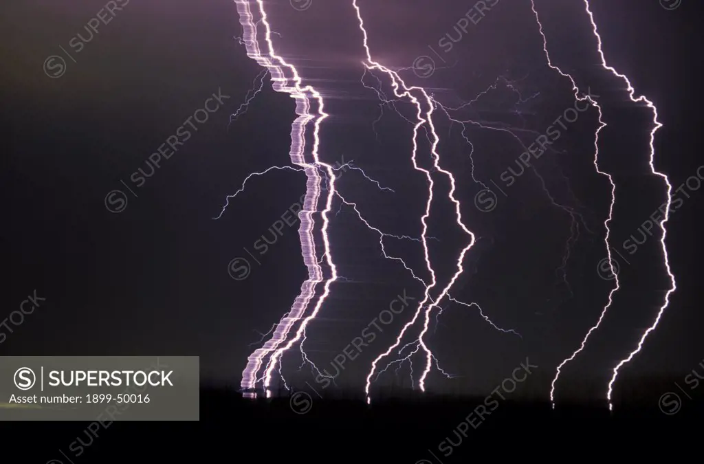 View of separated lightning strokes in a cloud-to-ground lightning strike. This view of scientific interest was made possible panning the camera from left to right during the interval of the lightning flash, thereby separating and recording the seven strokes in the one strike. Tucson, Arizona, USA.