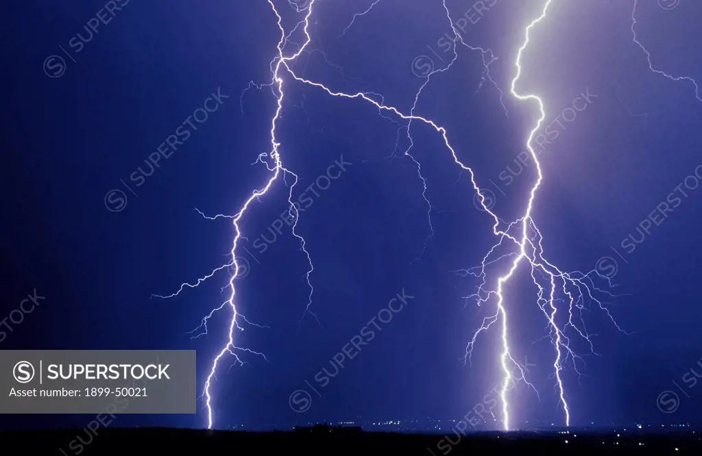 Cloud-to-ground lightning flashes.  Tucson, Arizona, USA.
