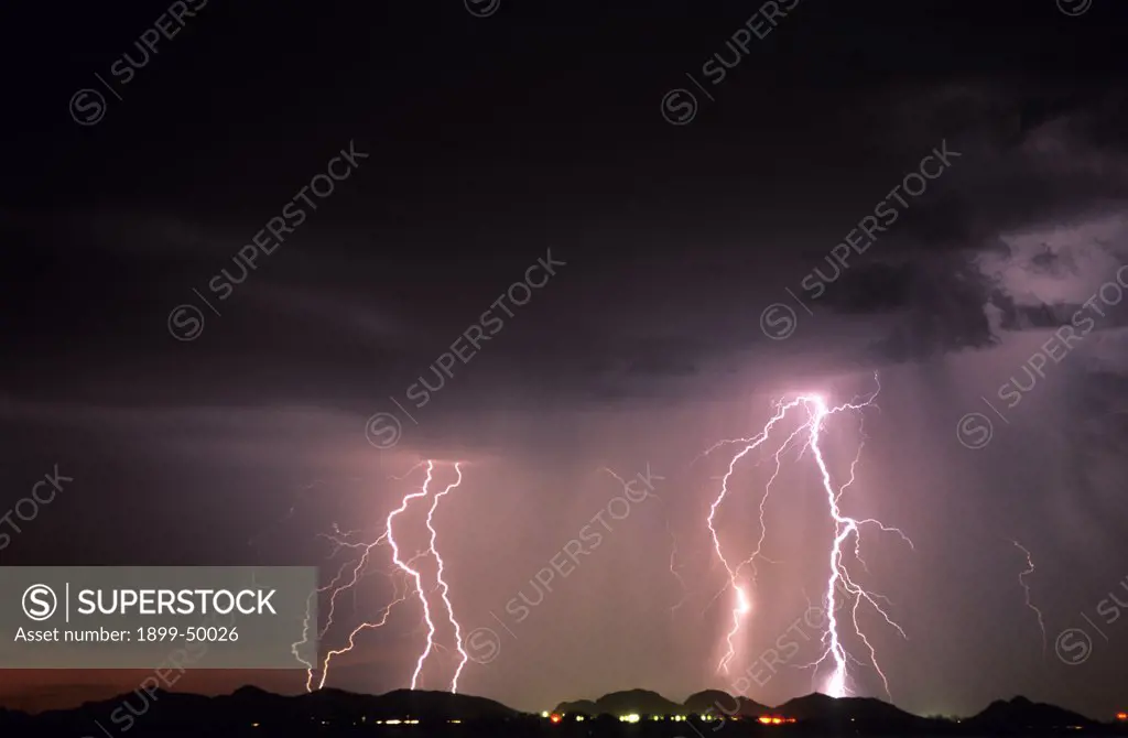 Cloud-to-ground lightning within a rain curtain.  Tucson, Arizona, USA.