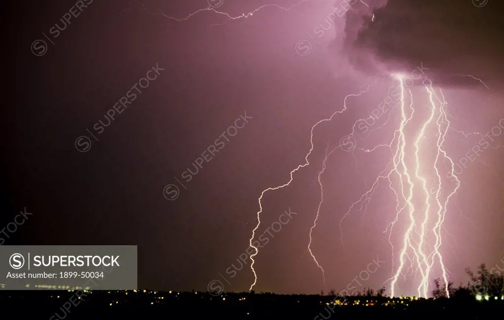Multiple cloud-to-ground lightning strikes from the leading edge of a storm cloud.   Tucson, Arizona, USA.