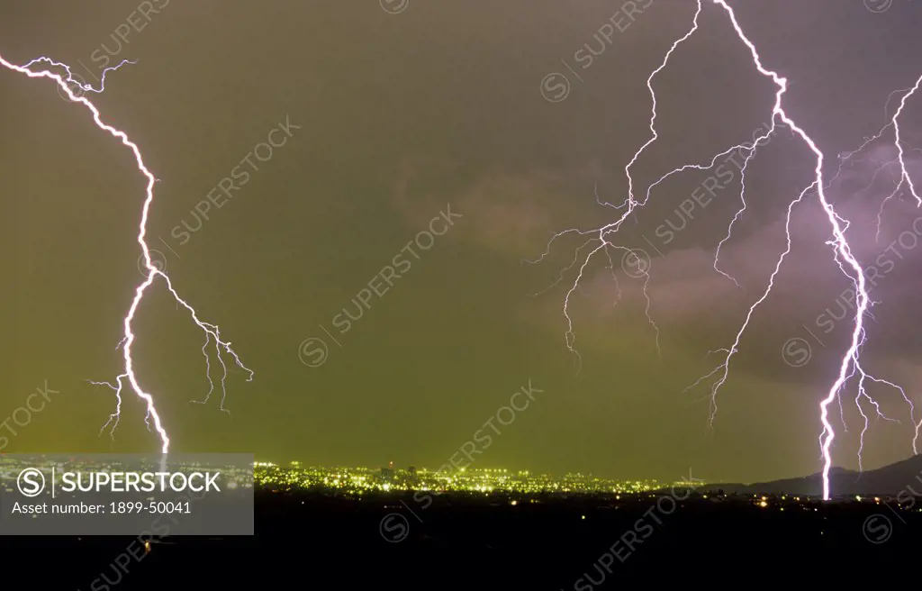 Two cloud-to-ground lightning strikes in the foothills of the Tucson Mountains.  Tucson, Arizona, USA.