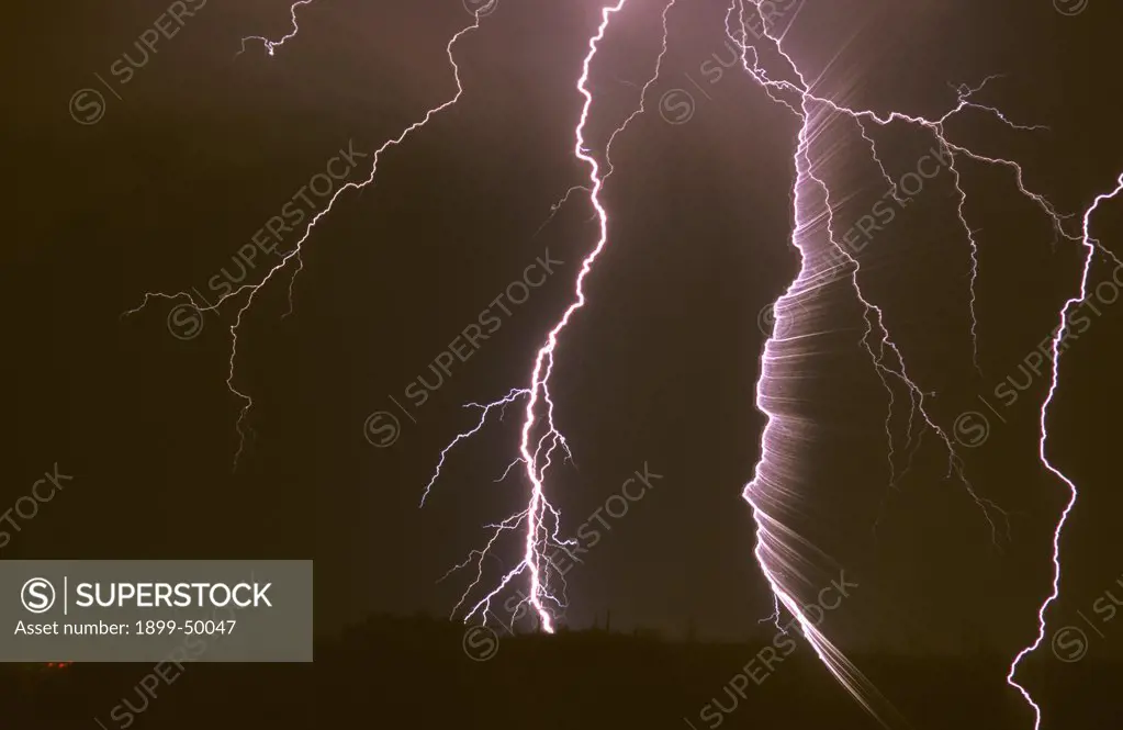 Surprising result from camera movement and lens zooming while recording multiple cloud-to-ground lightning strikes.  Tucson, Arizona, USA.
