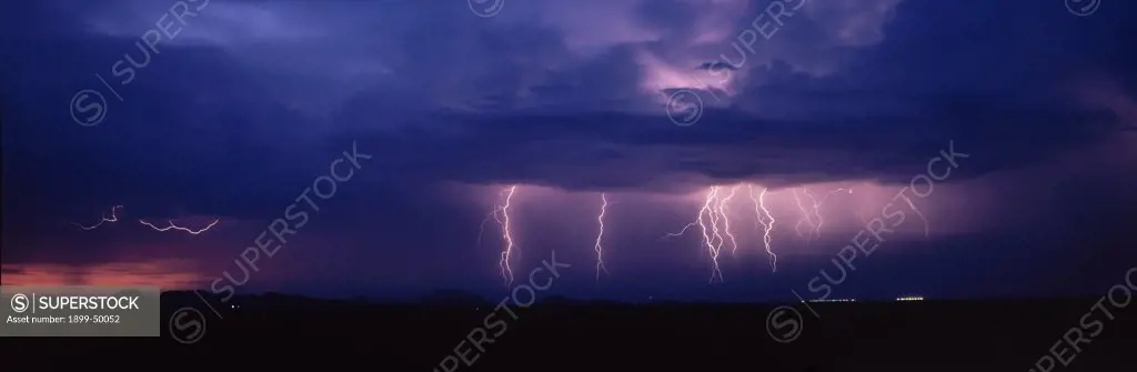 Electrical storm at sunset northwest of Tucson.  Summer monsoon season, Sonoran Desert. Southeastern Arizona, USA.  Panoramic 6x17 film