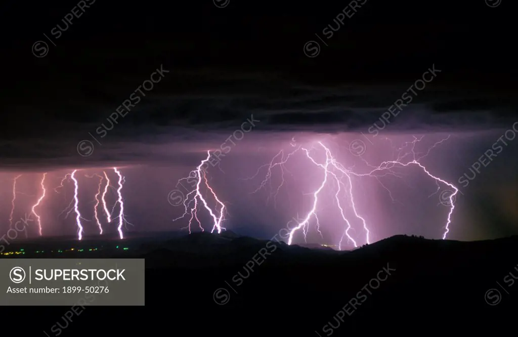 Violent storm with multiple cloud-to-ground lightning strikes.  Near Socorro, New Mexico, USA.