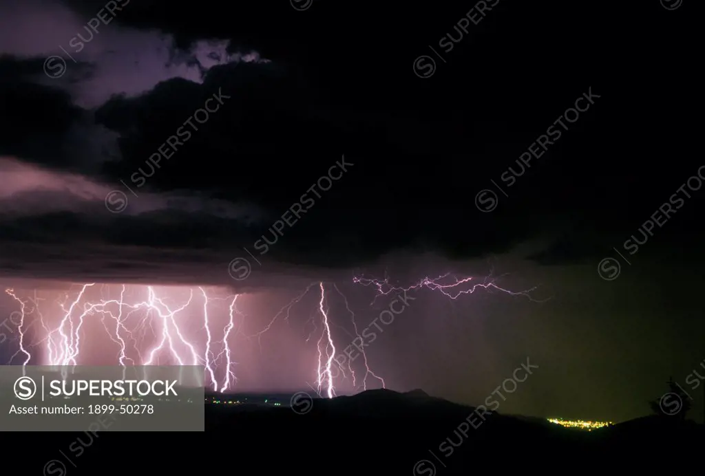 Active storm cell with multiple cloud-to-ground lightning strikes.  Near Socorro, New Mexico, USA.