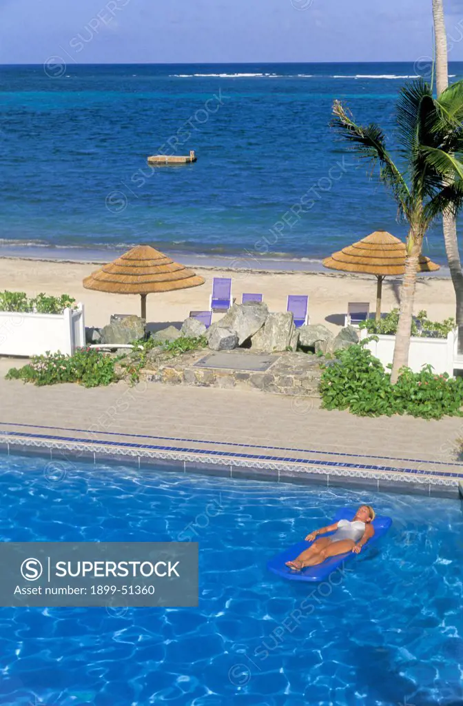 U.S. Virgin Islands, St. Croix. Divi Carina Bay Resort. Woman On Air Mattress In Pool.
