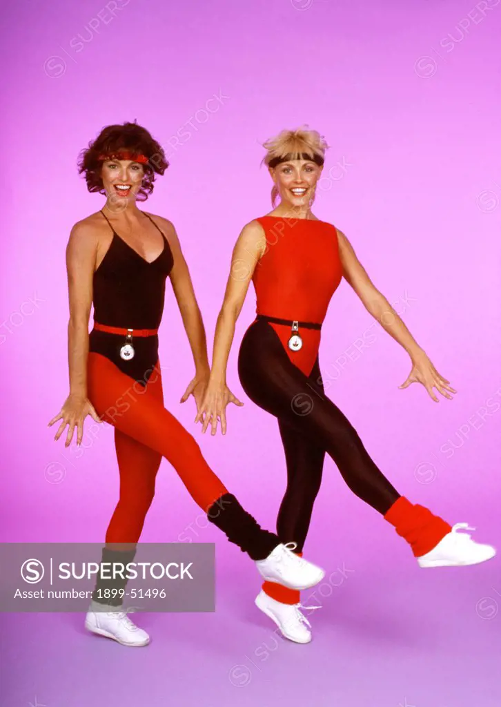 1980'S. Two Women In Workout Clothes Doing Aerobics.