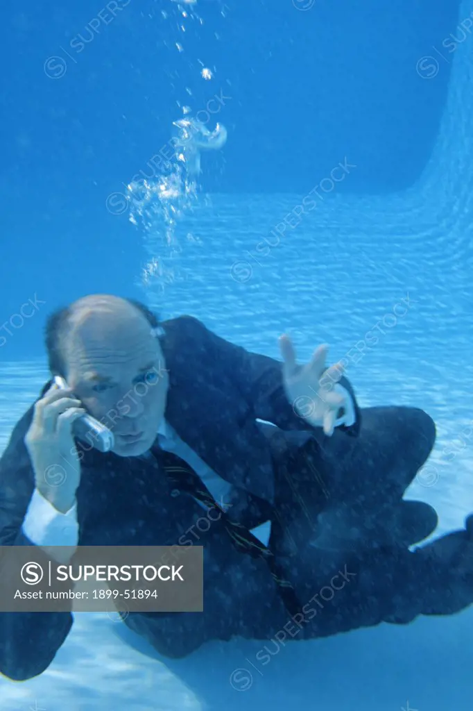 Businessman Underwater On Cellular Phone
