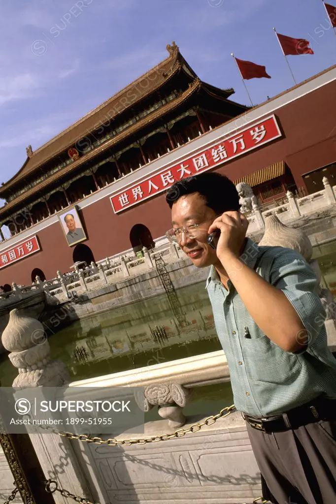China, Beijing, Tiananmen Square, Heavenly Gate. Man On Cell Phone