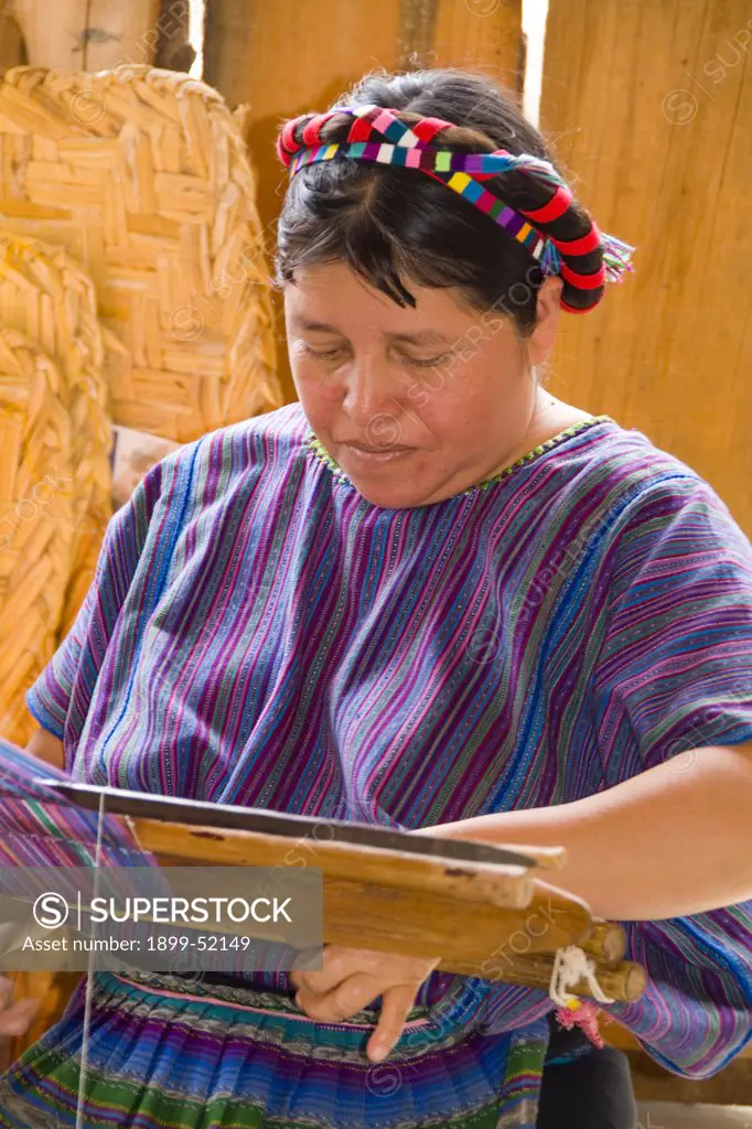 Guatemala, Woman Using A Loom To Weave Fabrics