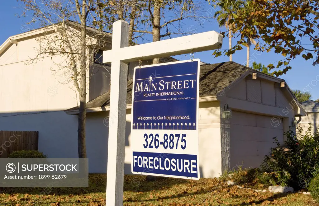 Home With Foreclosure Sign