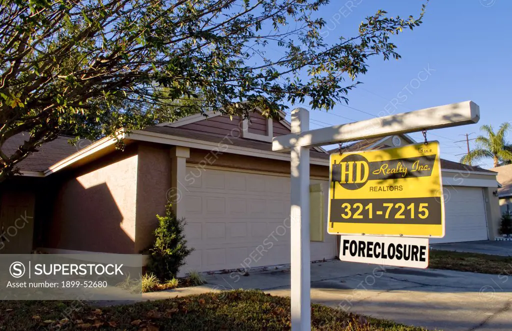 Home With Foreclosure Sign