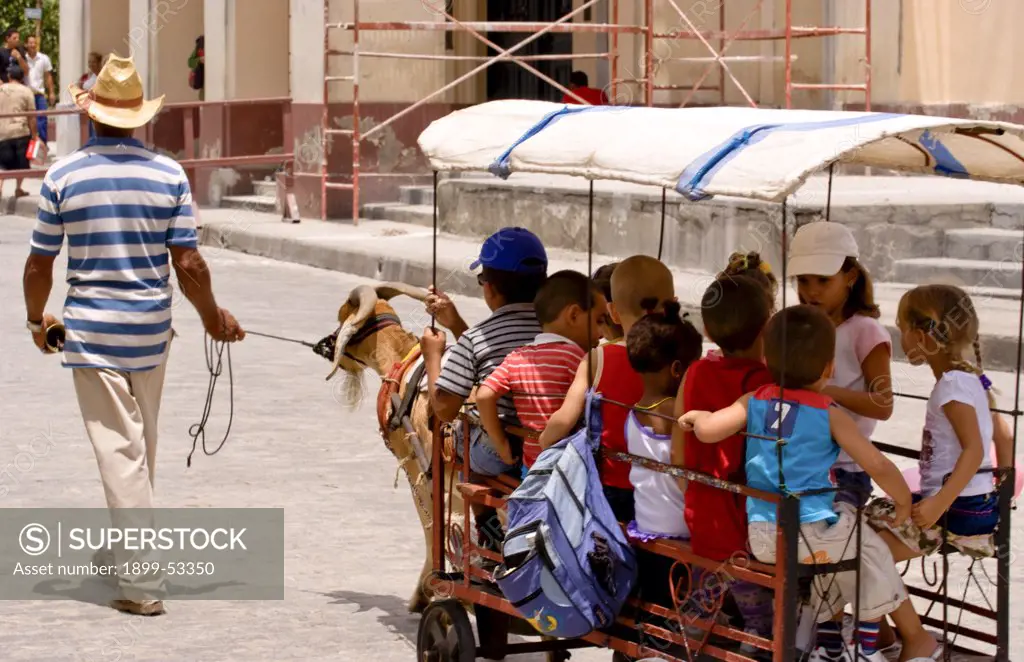 Local Children Celebrating With Goat Carriage Ride In Town Square In Santa Clara, Cuba