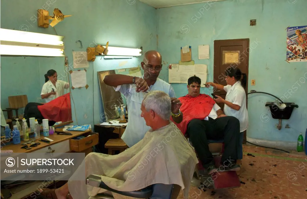 Small Local Barbershop With Barber Cutting Hair In Small Town Of Cojimar, Cuba