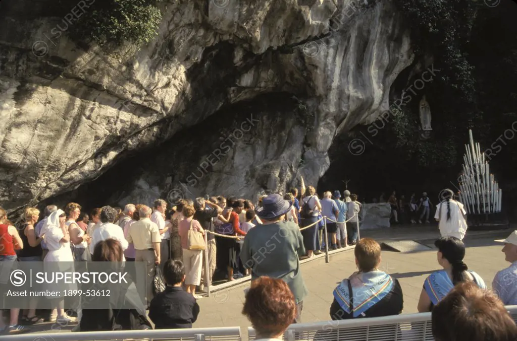 France. Lourdes.Pilgrims Waiting To Enter The Grotto Of Miraculous Appearances Of Our Lady (Grotte Massabielle).