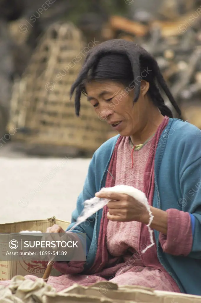 India. Arunachal Pradesh, Tawang. Woman Spinning Cotton Thread