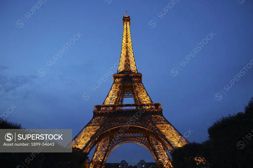 An Evening Dusk Blue Sky Eiffel Tower Lit By Warm Lights, Paris, France, Europe