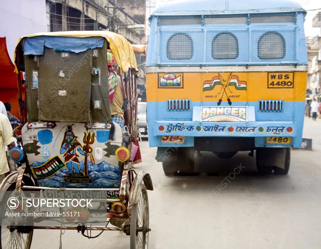 Man Pulling Hand Rickshaw Behind Bus. Calcutta Now Kolkata, West Bengal, India
