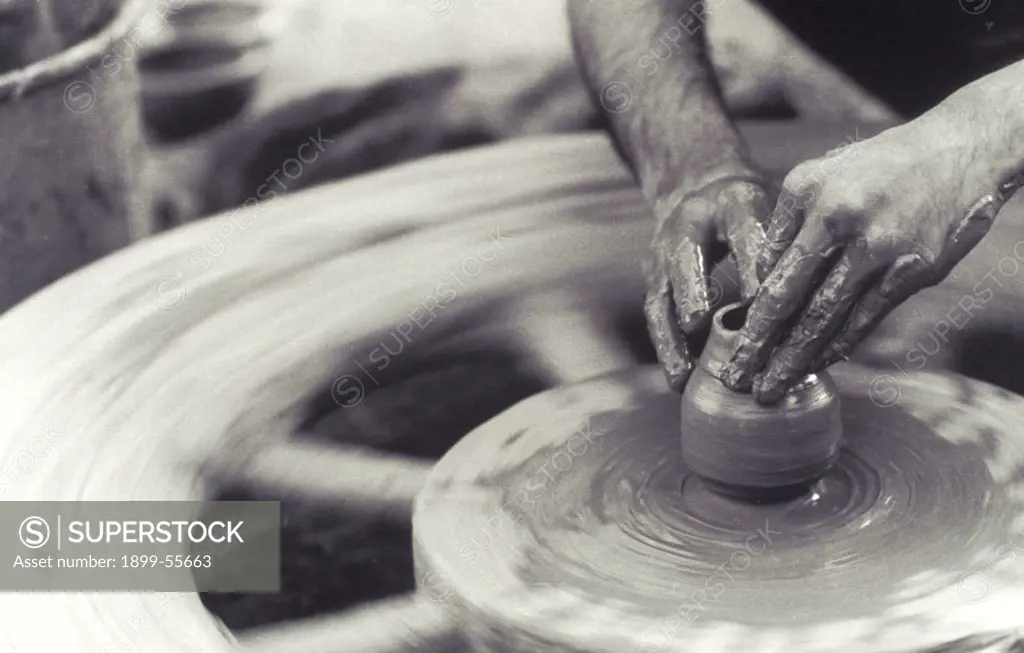 India. Potter Throwing Pot On Wheel