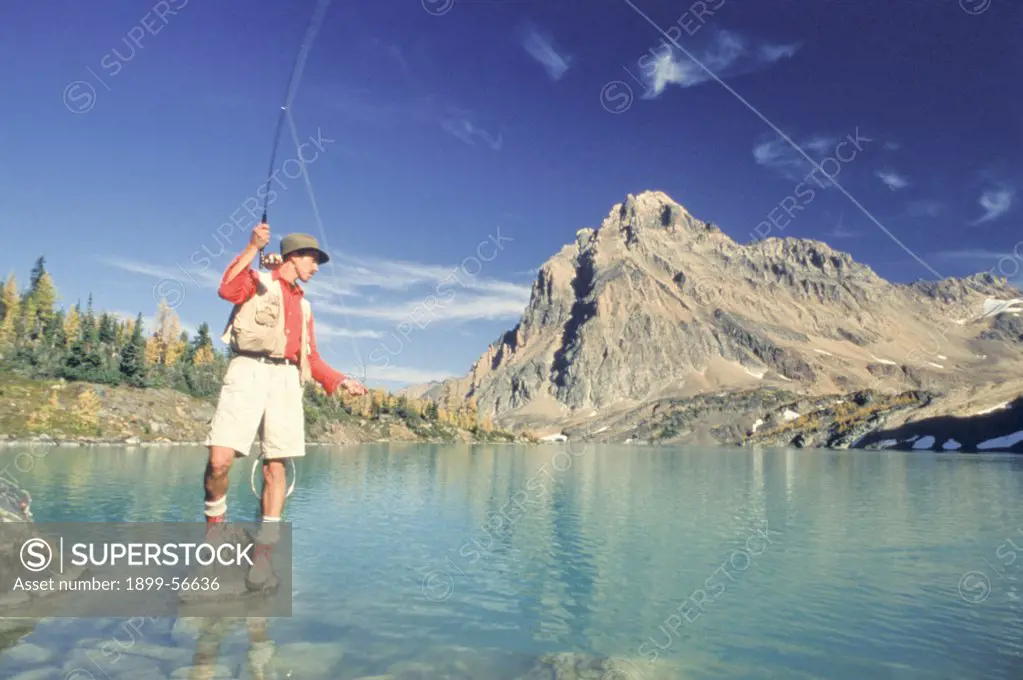 Canada, British Columbia, Purcell Mountains. Man Fly Fishing