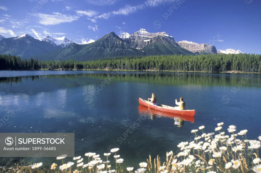 Canada, Canadian Rockies, Banff, Herbert Lake. Couple Canoeing.