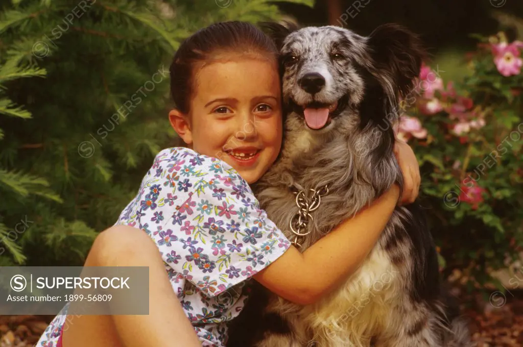 Girl Hugging Her Dog