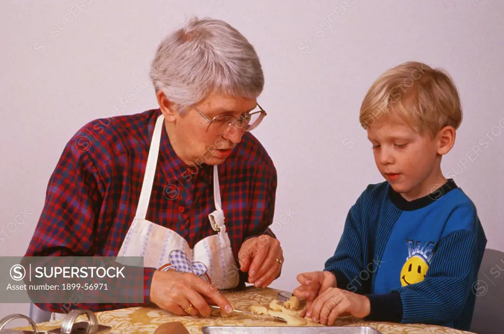 Grandmother And Grandson Making Cookies.