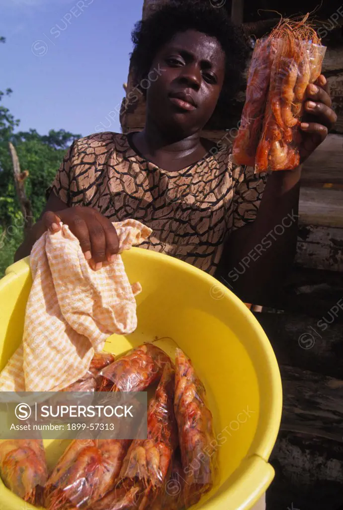 Jamaica. Middle Quarters. Woman Offering Pepper Shrimp