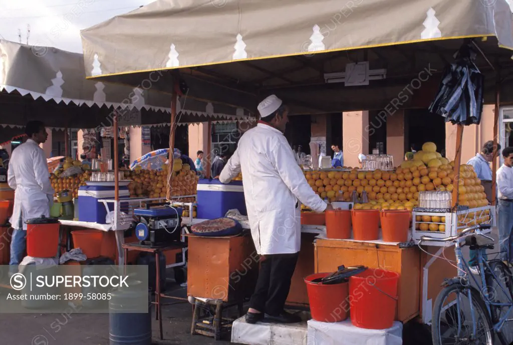 Morocco, Marrakesh. Men At Outdoor Stands Selling Fresh Orange Juice.