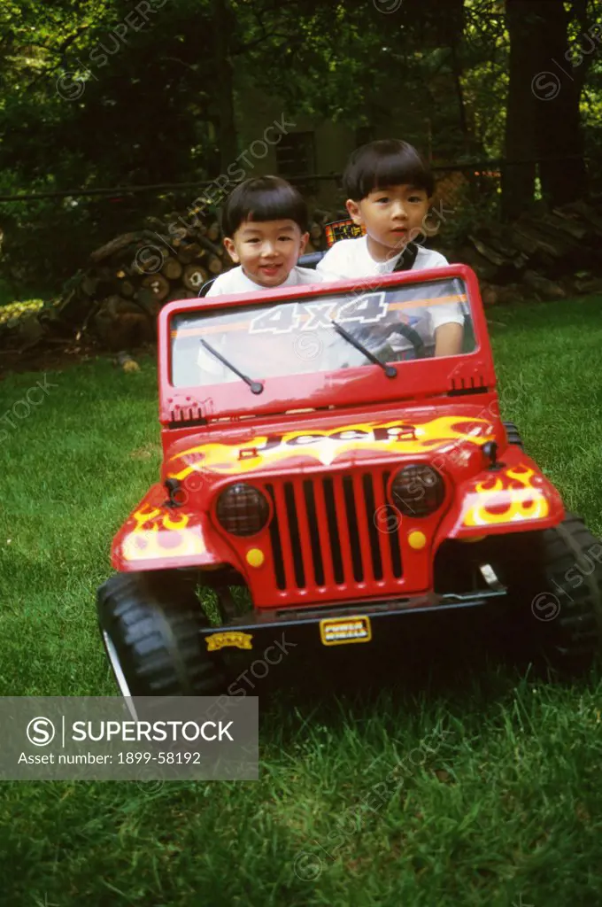 Chinese-American Boys (2 And 5 Years Old) Playing In Toy Jeep