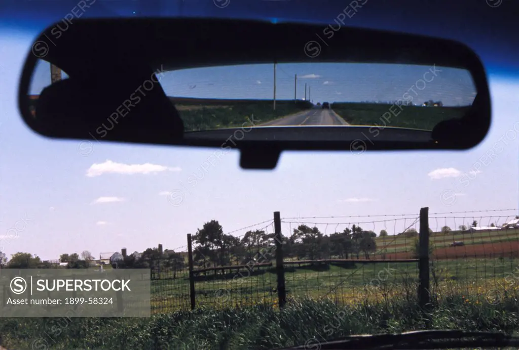 Rural Scene As Viewed Through Car Rear View Mirror And Windshield