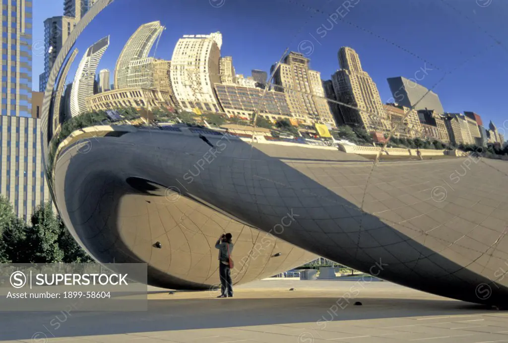 Illinois. Chicago. Millennium Park. Kapoor Sculpture ""Cloudd Gate"" (Aka ""The Bean."" ) Reflection & Michigan Avenue Buildings.
