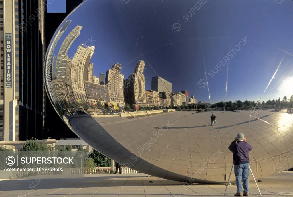 Illinois. Chicago. Millennium Park. Kapoor Sculpture ""Cloud Gate"" (Aka ""The Bean."" ) Reflection & Michigan Avenue Buildings.