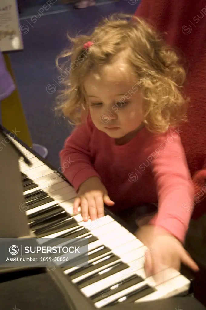 Two Year Old Girl Playing The Piano