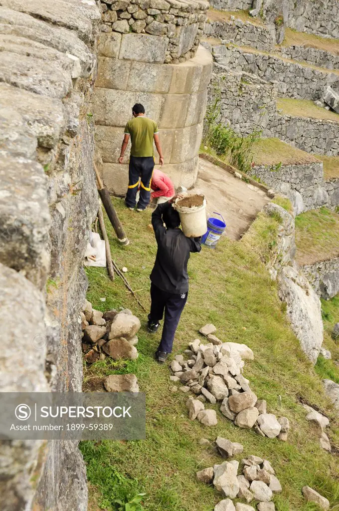 Workers Repair Macchu Picchu Walls, Peru