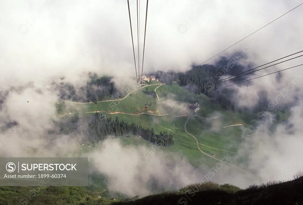 Switzerland. Aerial Cableway. View Through Clouds. Mountain Valley. Roads.