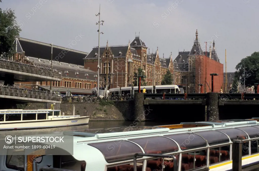 Netherlands. Amsterdam. Centraal Station. Canal. Tour Boats. Bicycle Parking.