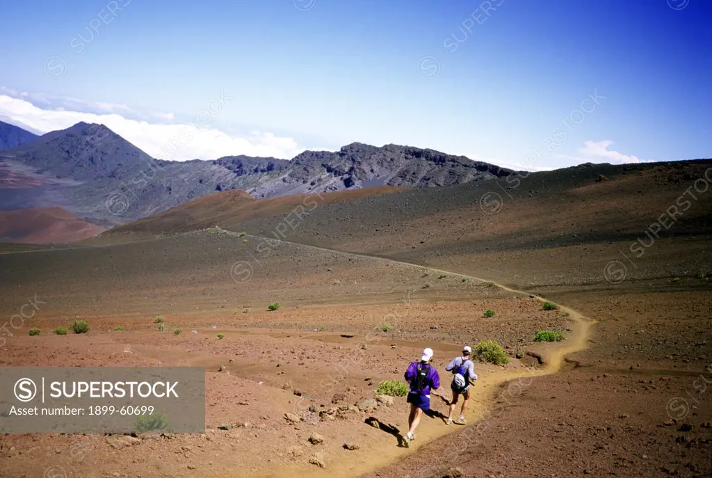 Two Men Running On The Sliding Sands Trail In The Haleakala Crater National Park. Maui, Hawaii