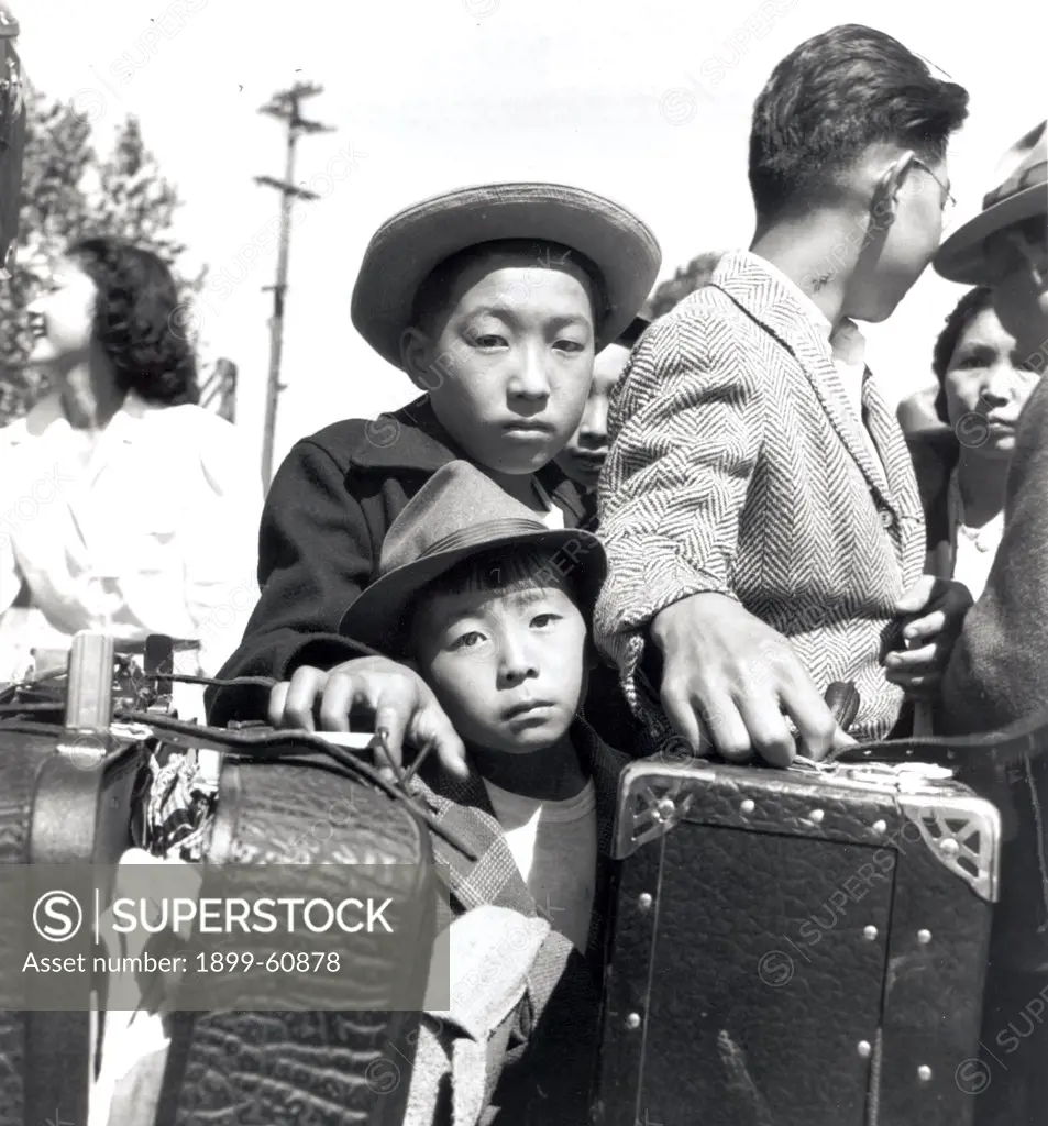 Turlock, California. These Young Evacuees Of Japanese Ancestry Are Awaiting Their Turn For Baggage Inspection At This Assembly Center. 05/02/1942 Photographer: Dorothea Lange