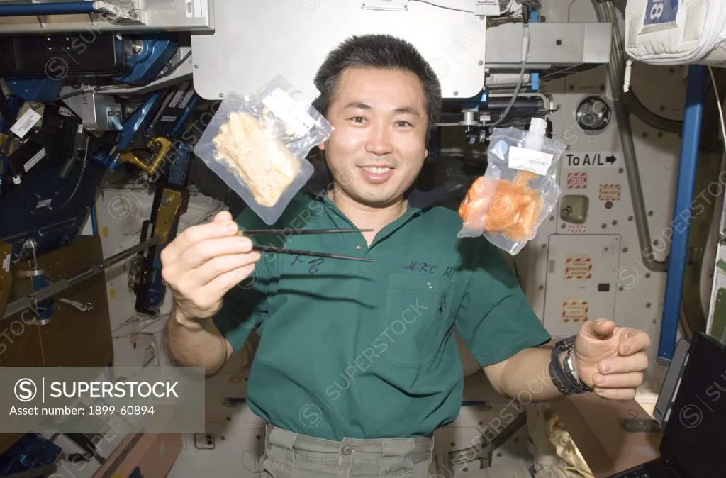 3 June 2009. Japan Aerospace Exploration Agency (Jaxa) Astronaut Koichi Wakata, Expedition 20 Flight Engineer, Holds Chopsticks Near Two Food Containers Floating Freely In Unity Node Of The International Space Station.