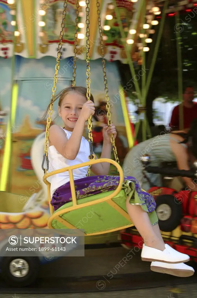 Girl Swinging On Carousel